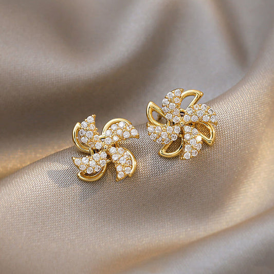 Earrings shaped like a small rotating windmill