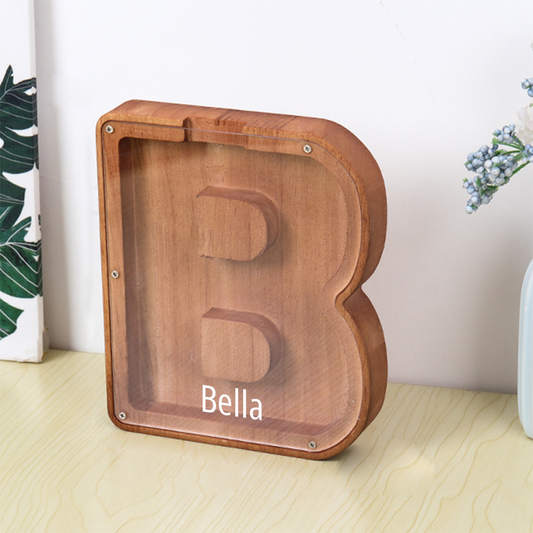 Personalized wooden piggy bank with 26 letters and first name.