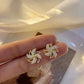 Earrings shaped like a small rotating windmill