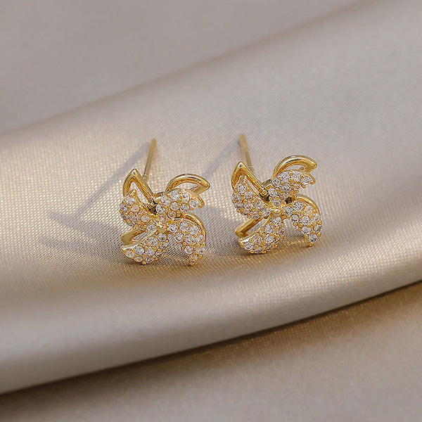 Earrings shaped like a small rotating windmill